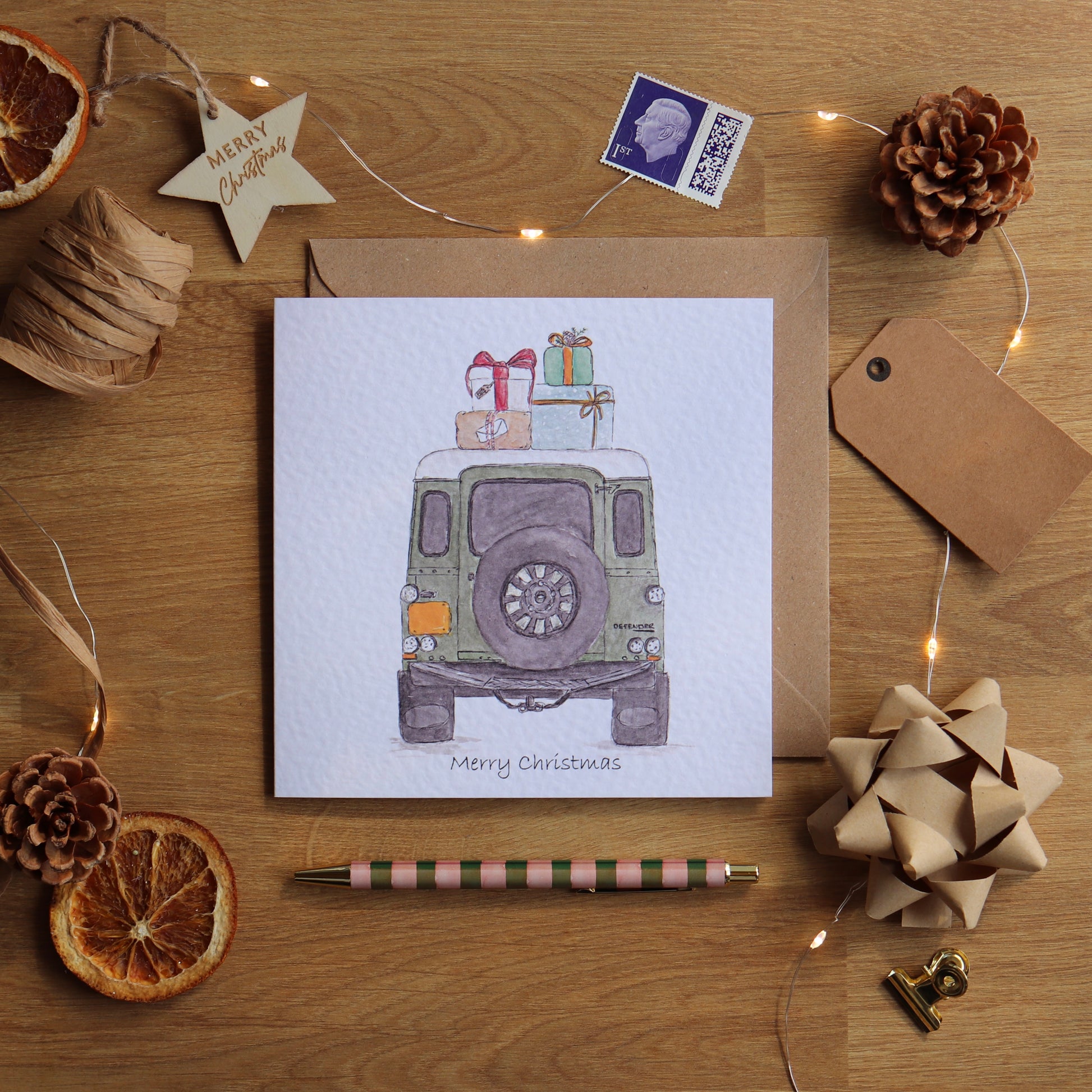 Christmas card with illustration of defender loaded with presents