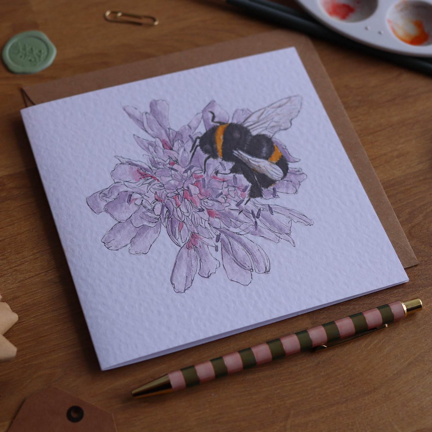 Greeting card with illustration of bee on purple dahlia flower