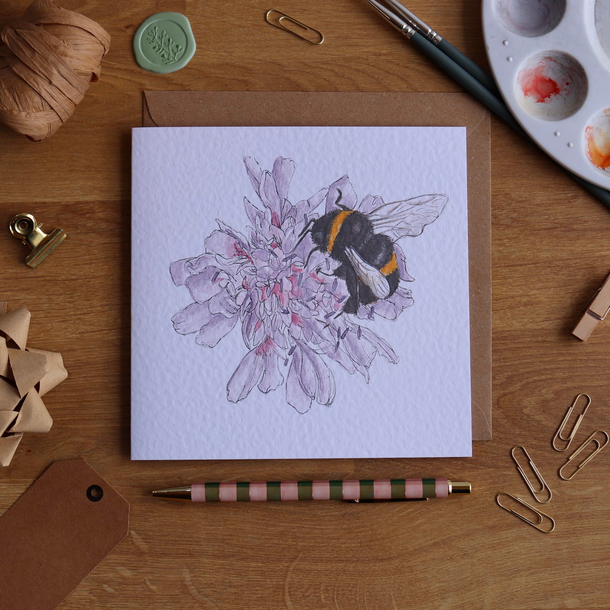 Greeting card with illustration of bumble bee on flower
