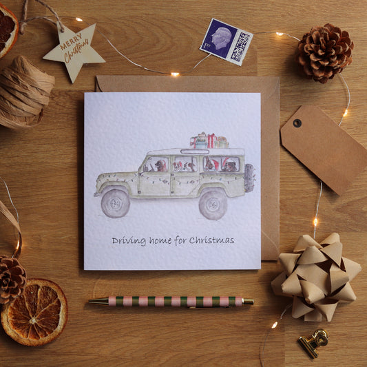Christmas card with illustration of defender full of festive dogs