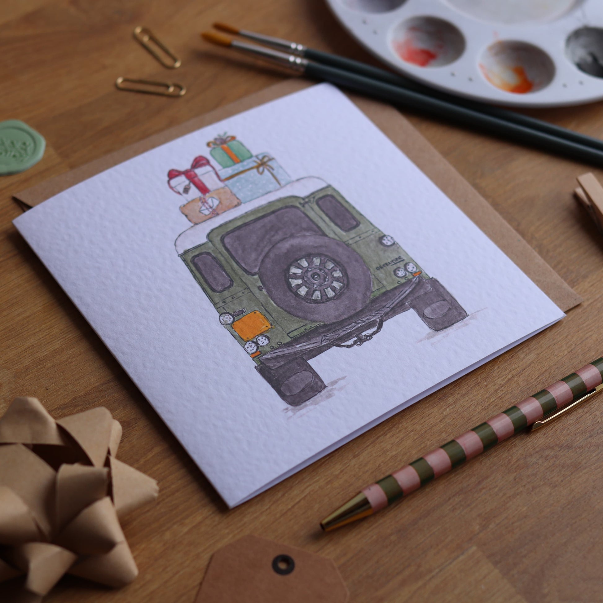 Greeting card with illustration of defender stacked in presents