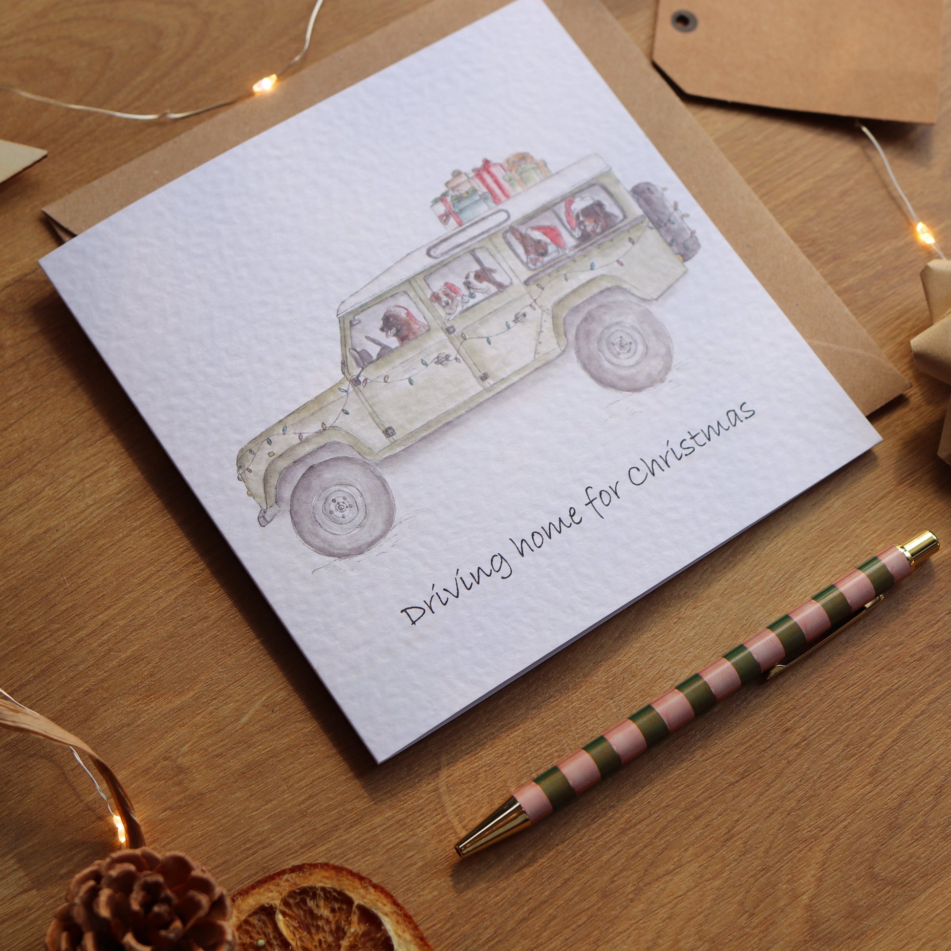 Christmas card with illustration of defender full of festive dogs