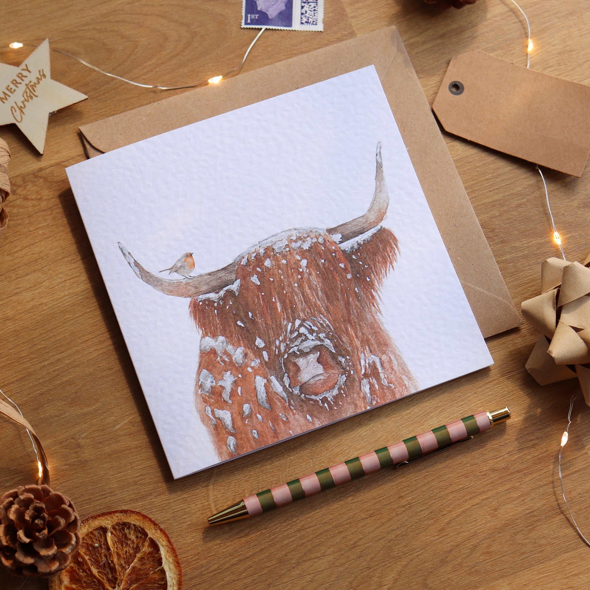 Christmas card with illustration of highland cow and robin
