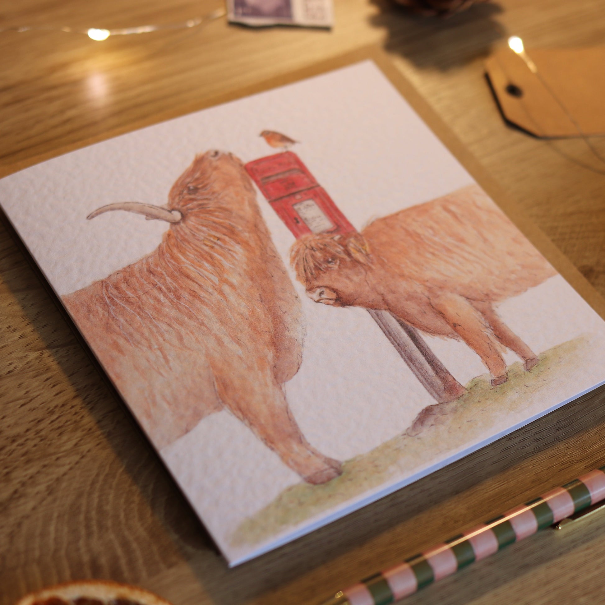 Greeting card with illustration of highland cows