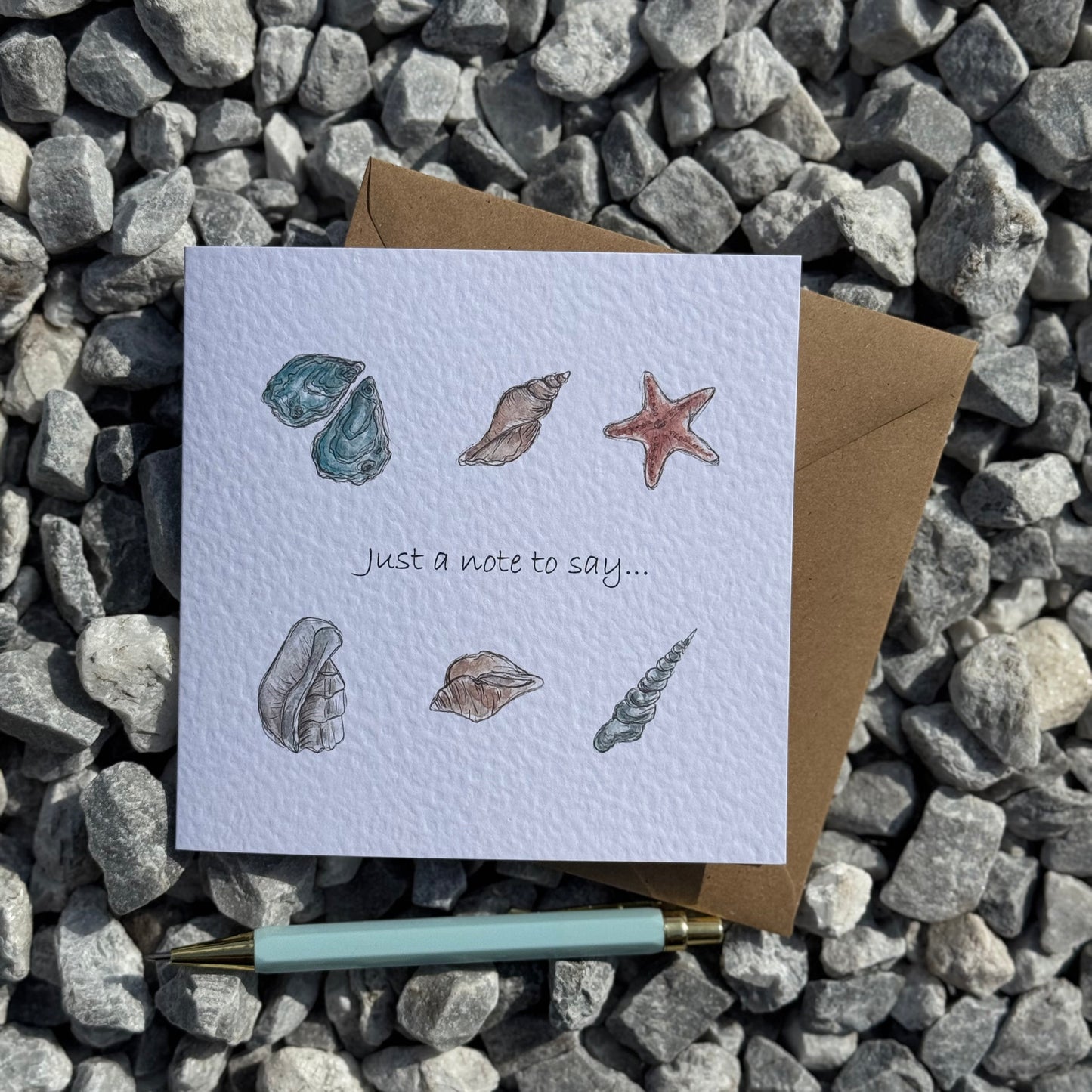 Greeting card with illustration of shells and wording just a note to say