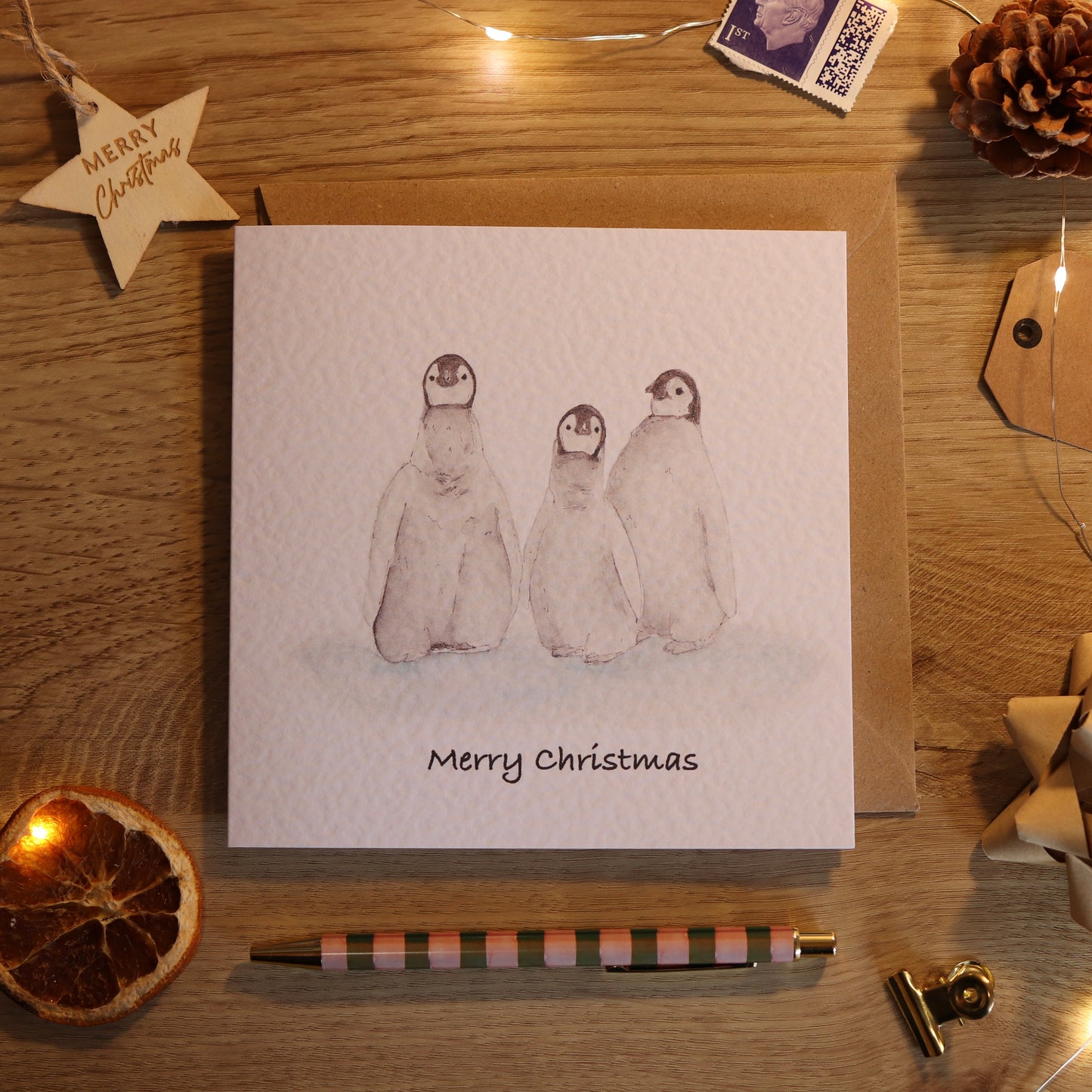 Christmas c and with illustration of 3 penguin babies
