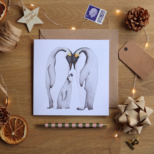 Christmas card with illustration of family of penguins