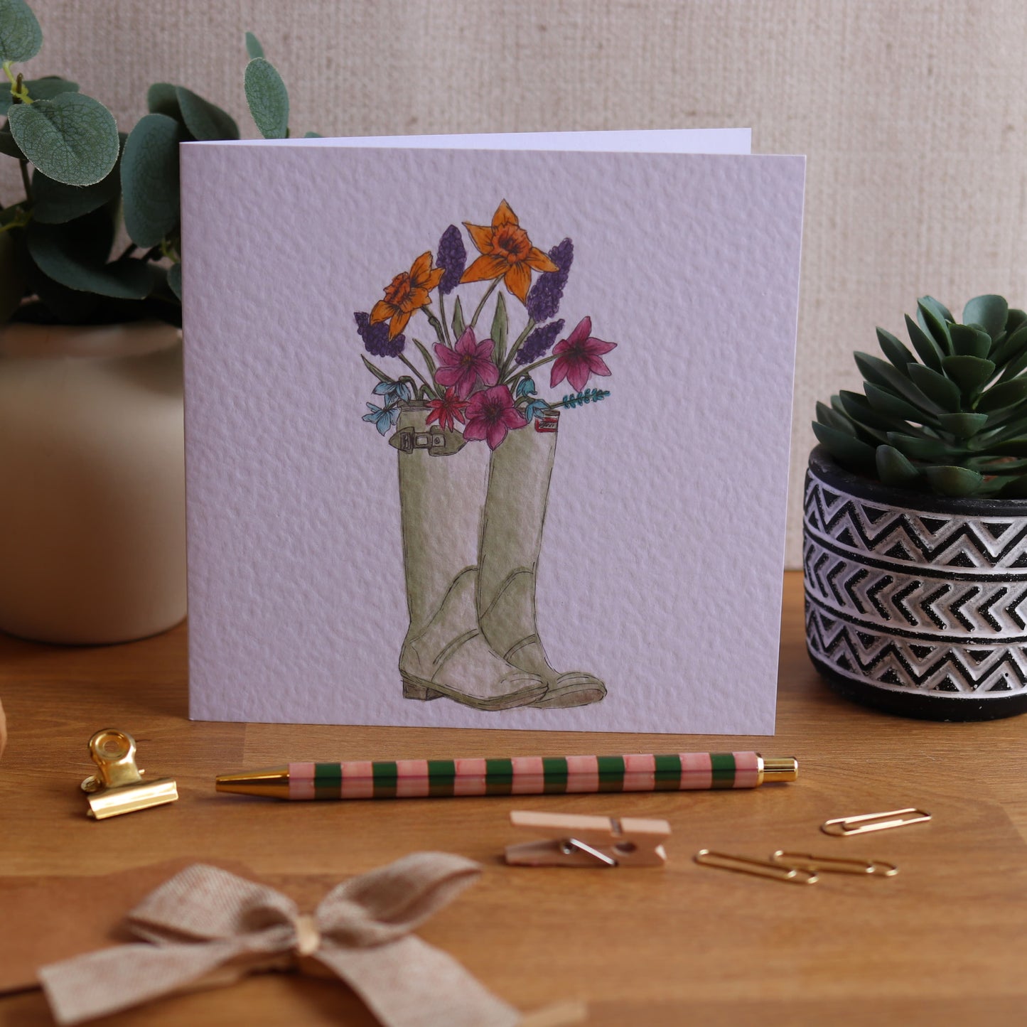 Greeting card with illustration of wellies and flowers